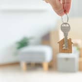 Woman hold key house keychain in new apartment. (Pic credit: AdobeStock)