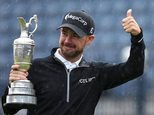 Unlikely hero: Brian Harman of the United States holds aloft the Claret Jug and gestures a thumbs up to the crowd as the rain pours on the 18th green following his win in the Open at Royal Liverpool (Picture: Jared C. Tilton/Getty Images)