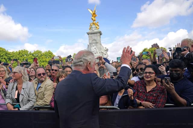 King Charles III is greeted by well-wishers during a walkabout to view tributes left outside Buckingham Palace, London, following the death of Queen Elizabeth II on Thursday. Picture date: Friday September 9, 2022. PA Photo. See PA story DEATH Queen. Photo credit should read: Yui Mok/PA Wire
