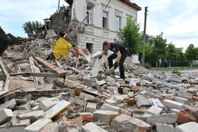 A policeman searches through the wreckage of a building after the explosion of a Russian rocket in the northwestern outskirts of Kharkiv on June 26, 2022, amid the Russian invasion of Ukraine. PIC: SERGEY BOBOK/AFP via Getty Images.