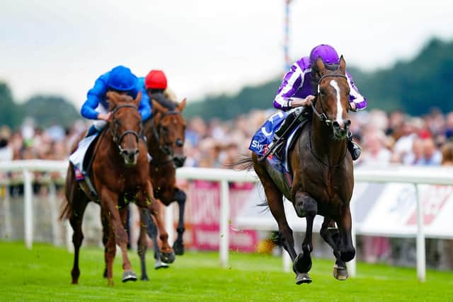 CATCH ME IF YOU CAN: Continuous and Ryan Moore (right) win the Sky Bet Great Voltigeur Stakes on day one of the Ebor Festival at York Racecourse. Picture: Mike Egerton/PA