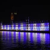 The Palace of Westminster is lit up in the colours of Israel's flag for victims and hostages of Hamas attacks. PIC: Lucy North/PA Wire