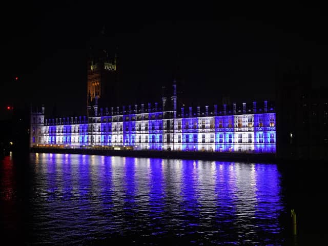 The Palace of Westminster is lit up in the colours of Israel's flag for victims and hostages of Hamas attacks. PIC: Lucy North/PA Wire