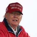 Former US president Donald Trump wearing a cap with his 'Make America Great Again' slogan. PIC: Brian Lawless/PA Wire