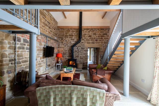 The double height granary is now a spacious sitting area with mezzanine bedroom above