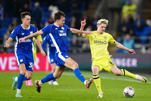 Huddersfield Town's Jack Rudoni and Cardiff City's Ryan Wintle battle for the ball during the Sky Bet Championship match at the Cardiff City Stadium. Picture: David Davies/PA Wire.