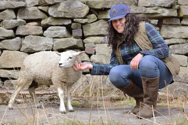 Grace Olson with lamb Bambi. Photo: Soni Davies
