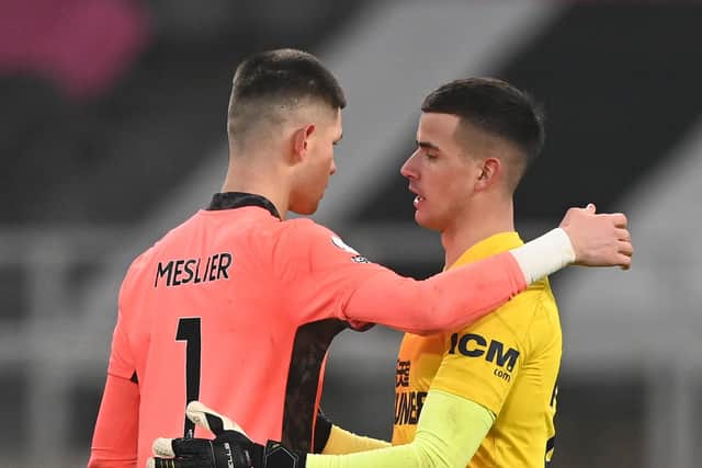 NEWCASTLE UPON TYNE, ENGLAND - JANUARY 26: The two goalkeepers embrace after the game, Illan Meslier of Leeds and Karl Darlow (r) during the Premier League match between Newcastle United and Leeds United at St. James Park on January 26, 2021 in Newcastle upon Tyne, England. Sporting stadiums around the UK remain under strict restrictions due to the Coronavirus Pandemic as Government social distancing laws prohibit fans inside venues resulting in games being played behind closed doors. (Photo by Stu Forster/Getty Images)