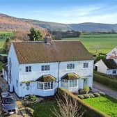 The semi-detached house is in a sought-after village with views over fields and hills