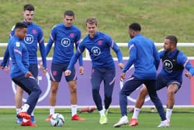 England's striker Patrick Bamford (C) and team-mates attend an England training session at St George's Park.
