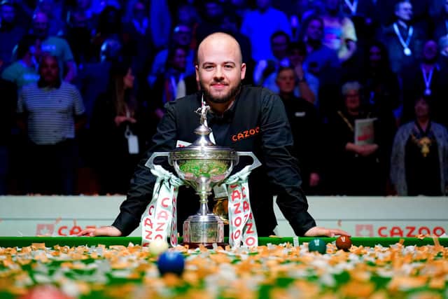Luca Brecel celebrates with the trophy after beating Mark Selby to win the final. Picture: Zac Goodwin/PA Wire.