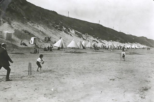 Children playing cricket on the beach at Saltburn in 1913.