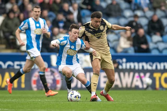 Huddersfield Town loanee Cameron Humphreys challenges Rotherham United's Shaun McWilliams in the League One derby in March. Photo: Tony Johnson.