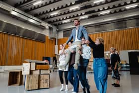 Callum Thorpe as Diktat being lifted by the dancers during Masque of Might rehearsals. Picture: Tom Arber