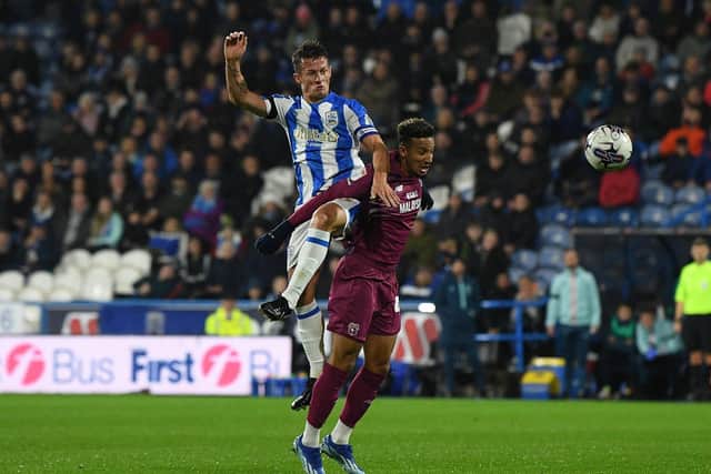 Huddersfield Town captain Jonathan Hogg gets above Cardiff City opponent Callum Robinson in the Championship game at the John Smith's Stadium in October. Picture: Jonathan Gawthorpe.