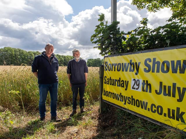 Steve Hogg, a dairy farmer, and sheep secretary/steward for Borrowby Show pictured with Lester Peel and show sign.