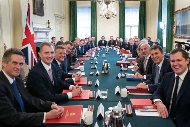 Rishi Sunak poses for a photograph alongside members of his new cabinet at his first cabinet meeting in 10 Downing Street