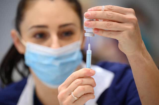 Medical staff and volunteers prepare shots of the Moderna vaccine at an NHS Covid-19 vaccination centre on December 16, 2021. PIC: Leon Neal - WPA Pool/Getty Images.