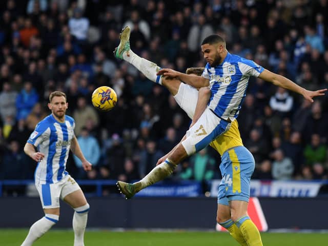 Huddersfield Town's Brodie Spencer battles with Sheffield Wednesday's Michael Smith in the Championship Yorkshire derby at the John Smith's Stadium in early February.Picture: Jonathan Gawthorpe.