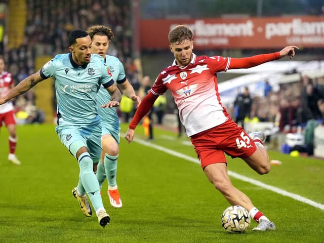 Bolton Wanderers' Joshua Dacres-Cogley (left) and Barnsley's John McAtee battle for the ball during the Sky Bet League One play-off, semi-final, first-leg match at Oakwell. Photo: Danny Lawson/PA Wire.