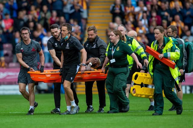 Emmanuel Osadebe is stretchered off after breaking his leg in the first meeting between Bradford City and Doncaster Rovers this season (Picture: Bruce Rollinson)