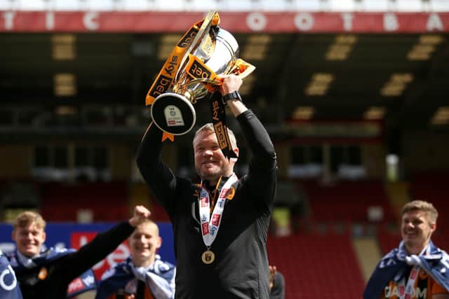 HAPPY DAYS: Hull City manager Grant McCann celebrates with the League One trophy in May 2021. Picture: Steven Paston/PA Wire.