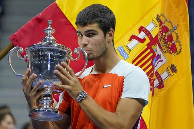 Carlos Alcaraz, of Spain, poses with the championship trophy after defeating Casper Ruud, of Norway, in the men's singles final of the U.S. Open tennis championships. (AP Photo/John Minchillo)