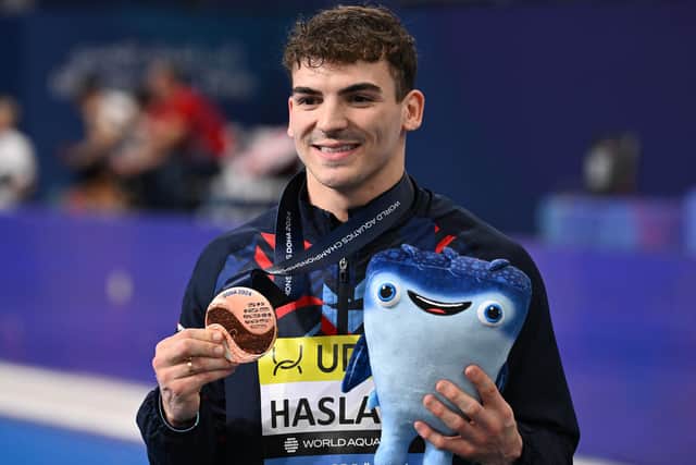 Britain's Ross Haslam poses with his bronze medal after the final of the men's 1m springboard diving event during the 2024 World Aquatics Championships at Hamad Aquatics Centre in Doha (Picture: SEBASTIEN BOZON/AFP via Getty Images)
