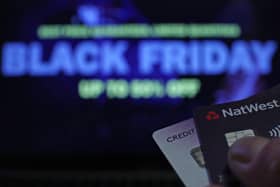 A person holding bank cards in front of a screen during 'Black Friday', in London, as hundreds of listings for potentially counterfeit products have been removed from Instagram ahead of Black Friday in a joint crackdown by Trading Standards and Meta.