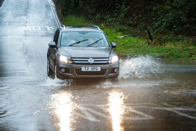 Cars travel through some flooding. (Pic credit: Kelvin Stuttard)