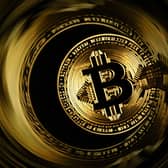 The Bitcoin logo displayed on a smartphone. (Photo by SEBASTIEN BOZON / AFP via Getty Images)