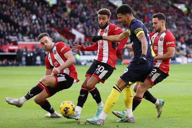 ANKLE INJURIES: Sheffield United defenders Jack Robinson (left) and Jayden Bogle (second from left) challenging Bournemouth's Dominic Solanke