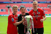MAGIC DAY: Barnsley's Lloyd Isgrove, manager Paul Heckingbottom and Marc Roberts celebrate with the League One play-off trophy after beating Millwall at Wembley ion May 2016. Picture: Nigel French/PA