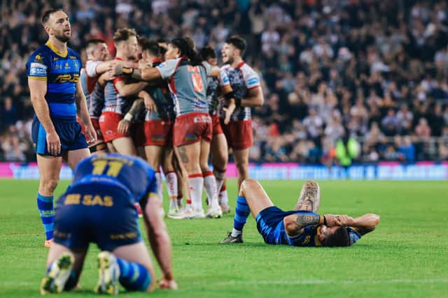 Wakefield slump to the floor after their relegation is confirmed. (Photo: Alex Whitehead/SWpix.com)