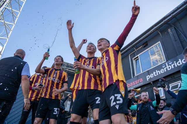 Bradford City star Bobby Pointon (far right), celebrates promotion in May with his Bantams' team-mates Tommy Leigh and former loanee Jack Shepherd. Photo: Tony Johnson.