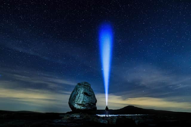 A walker looks up into the night sky above Twistleton Scar in The Yorkshire Dales National Park. Image: Danny Lawson/PA Wire