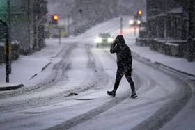 A man makes his way through a snow flurry. (Pic credit: Christopher Furlong / Getty Images)