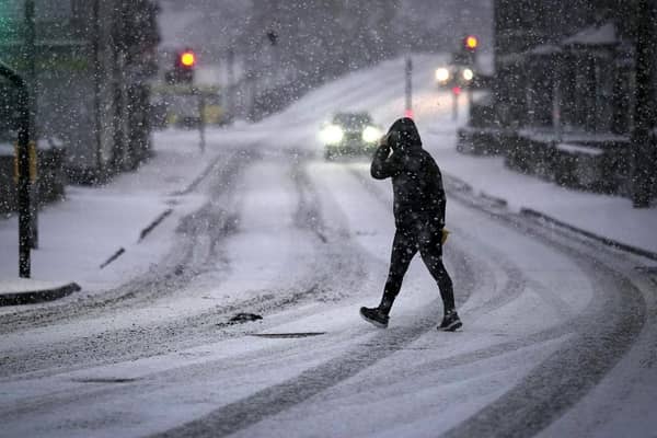 A man makes his way through a snow flurry. (Pic credit: Christopher Furlong / Getty Images)