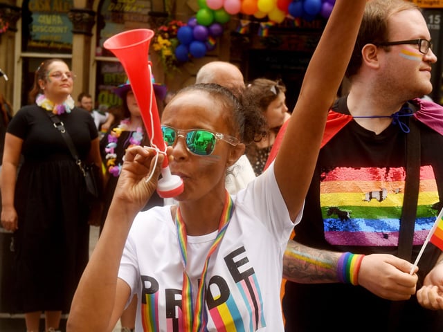 Crowds cheered as participants celebrated with music, dancing and rainbow flags
