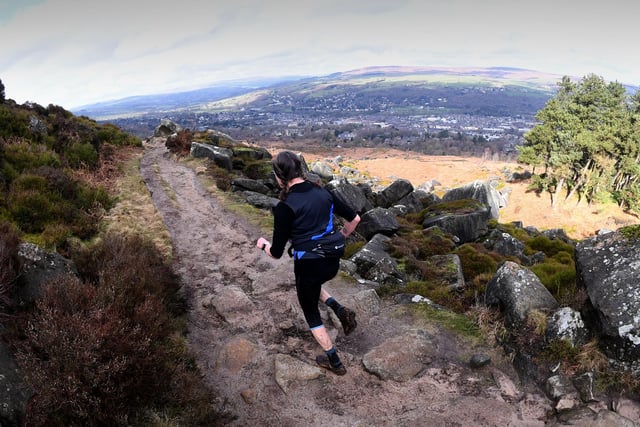 A runner races with the backdrop of the beautiful moors.