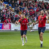 Positive vibes: York City captain Paddy McLaughlin, left, and Matty Brown with the trophy celebrating promotion to the National League in 2022, something they can call on in the FA Cup and the league this season (Picture: Tony Johnson)