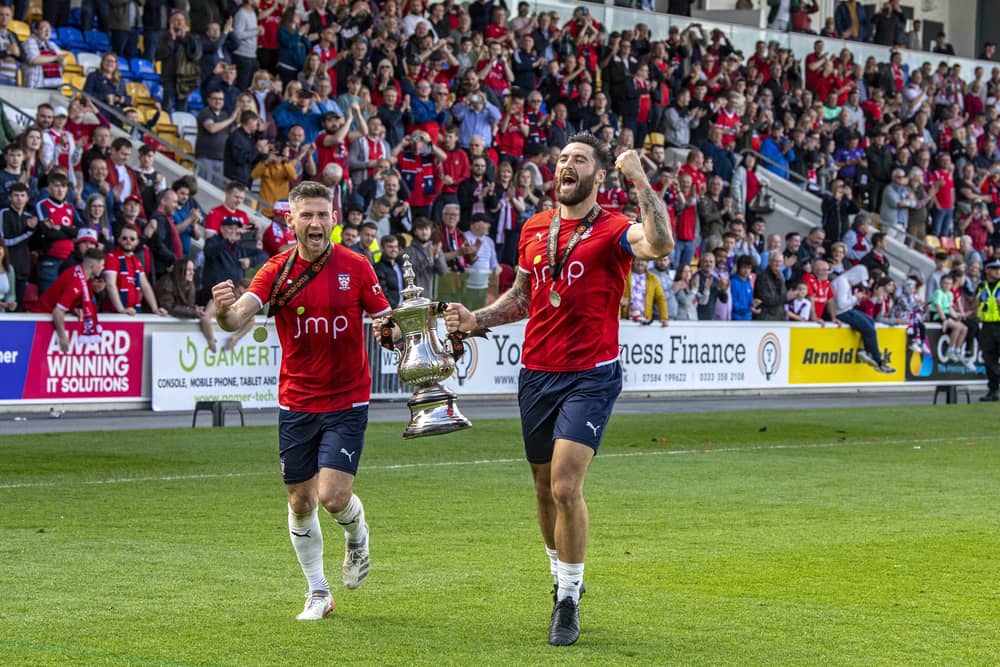 Positive vibes: York City captain Paddy McLaughlin, left, and Matty Brown with the trophy celebrating promotion to the National League in 2022, something they can call on in the FA Cup and the league this season (Picture: Tony Johnson)