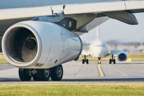 Hot air from jet engine against airplane taxiing to airport runway. 