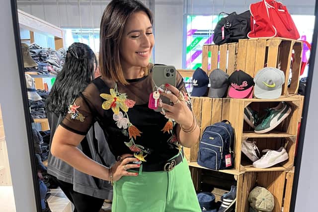 Inside the new St Luke’s shop, sustainability influencer Faye Wagstaffe wears gold platform heels from Vinted, and green wide-leg trousers, black embroidered and jewellery, all from charity shops. Picture: Faye Wagstaffe (@charity_shop_gal)