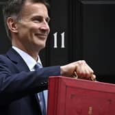 Chancellor Jeremy Hunt poses with the red Budget Box as he leaves 11 Downing Street on March 15, 2023, to present the government's annual budget to Parliament. PIC: JUSTIN TALLIS/AFP via Getty Images