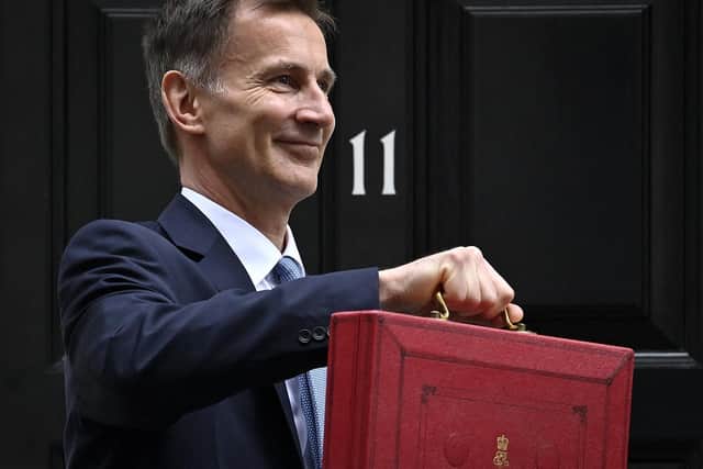Chancellor Jeremy Hunt poses with the red Budget Box as he leaves 11 Downing Street on March 15, 2023, to present the government's annual budget to Parliament. PIC: JUSTIN TALLIS/AFP via Getty Images