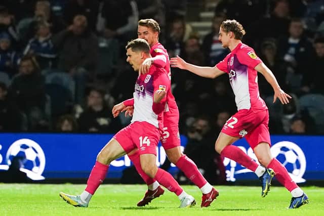 Huddersfield Town's Josh Ruffels (left) celebrates scoring their side's first goal of the game during the Sky Bet Championship match at Loftus Road, London. Picture: Zac Goodwin/PA Wire.