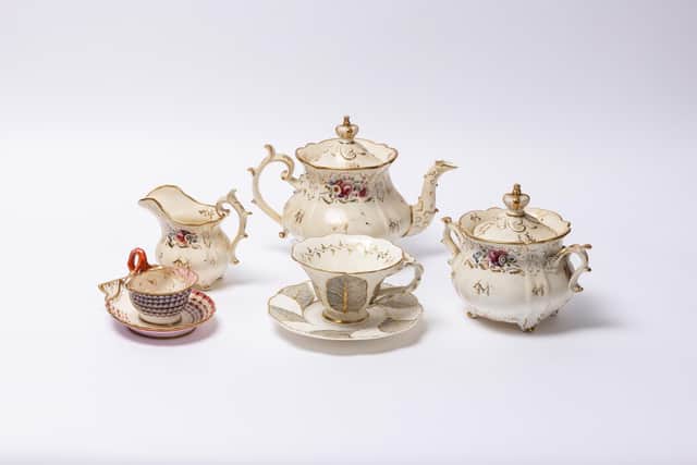 Back row: Matching gilded, floral-painted teapot, sucrier and jug with three spur handles. Front left: Cabinet cup and scallop-shaped saucer  Right: Primrose leaf patterned large tea cup and saucer