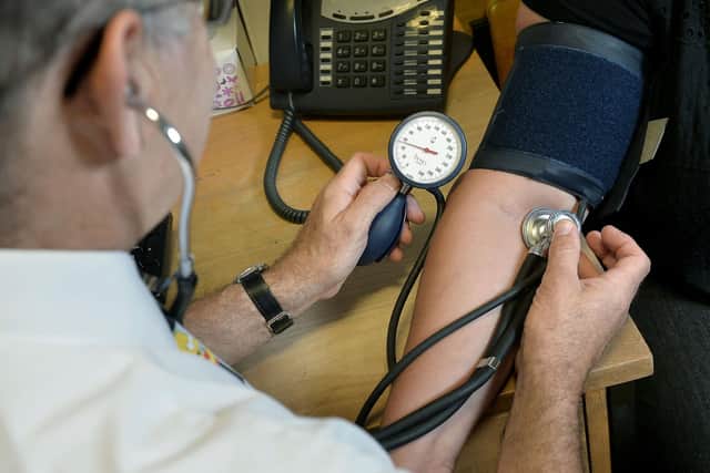 A GP checking a patient's blood pressure. PIC: PA