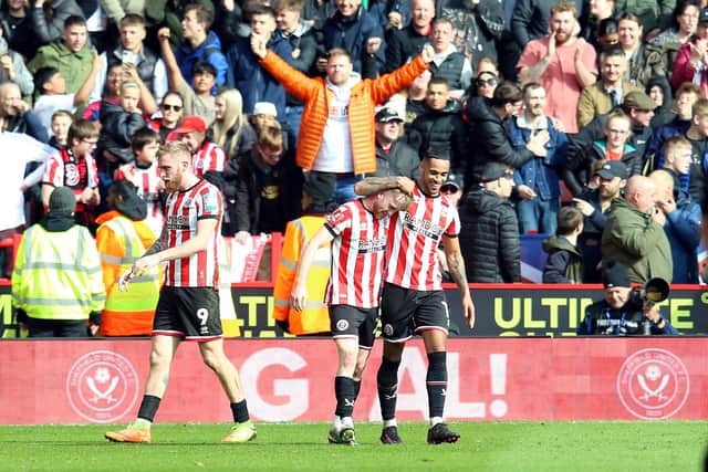 HERO: Sheffield United's Tommy Doyle (centre) celebrates his winning goal with team-mate Max Lowe